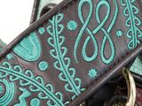 a close up of a purse with a keychain on it