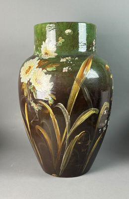 two vases with flowers painted on them on a table