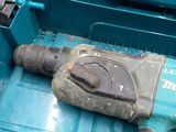 a drill that is laying on the floor next to a tool box