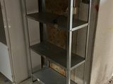 a metal shelf in the corner of a room
