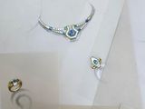 several pieces of jewelry are displayed on a table with a white background