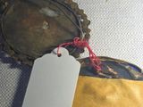 a bottle cap with a tag on it sitting on a table