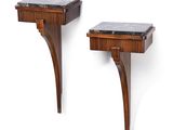 a pair of side tables with a marble top