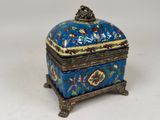 an image of a blue and gold box with flowers on it