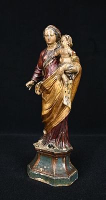 statue of a woman holding a child in her arms on a pedestal