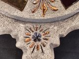 a close up of a clock on a stand on a table