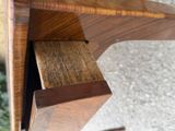 a close up of a wooden table with a drawer in it