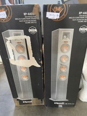 pair of speakers in boxes sitting on top of a table