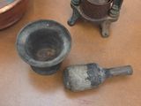 two old mortars on the table next to each other