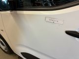 a small white car with a sticker on the side of it