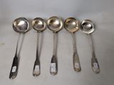 six spoons are lined up in a row on a table