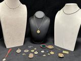 three mannequins with necklaces and other jewelry on a table
