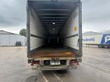 a truck that is sitting in a parking lot with it ' s door open
