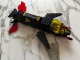 a lego model of a space ship on a marble surface