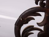 a close up of a metal object with a bird flying in the background