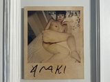 a picture of a woman sitting on a bed in a picture frame
