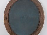 an image of a picture of a round mirror on a white wall