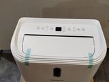 a white air purifier sitting on a pallet