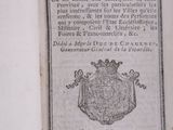 an old book with a picture of a coat of arms on it