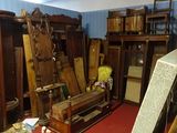 a room with a lot of old furniture and a red carpet