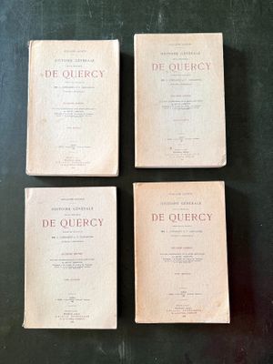 three old books sitting on top of a table next to each other