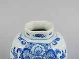 a blue and white vase sitting on a table