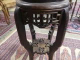 a table with a vase on top of it on a rug