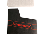 a nintendo logo on a piece of paper next to a piece of paper