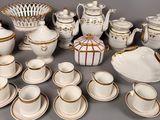 many different types of tea and coffee cups and saucers on the table