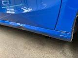 a close up of a blue car that has been dented