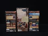 two boxes of games are sitting on a black surface