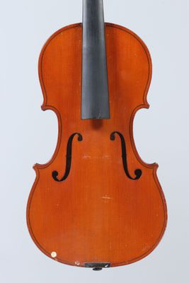 an old violin sitting on top of a wooden stand