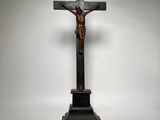 a cross with a crucif on a pedestal on a white background