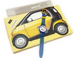 a small yellow smart car with a blue strap on it