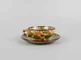 a cup and saucer on a saucer on a table