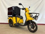 a yellow scooter with a black box on the back