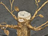 a glass table with a gold tree on top of it
