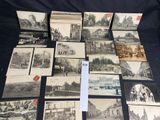 a lot of old black and white pictures on the table