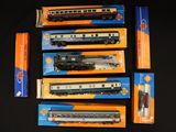 several boxed train cars are lined up on a black surface