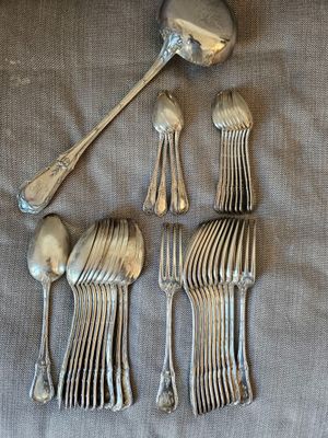 four silver spoons and a spoon with a spoon rest on a table