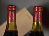 two bottles of wine sitting next to each other on a table