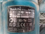 a close up of a blue machine with a label on it