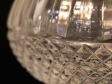 a clear glass bowl with a lid on a black surface