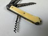 a swiss army knife with a corkscrew attached to it