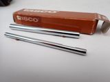 two metal straws sitting on a table next to a box