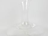 a clear glass vase sitting on a white surface