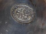 a close up of a metal object with a medallion on it