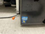 a close up of a microwave on the floor