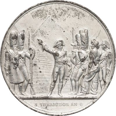 une pièce d'argent sur laquelle figure l'image d'un groupe de personnes