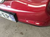 a close up of a red car with a license plate on it